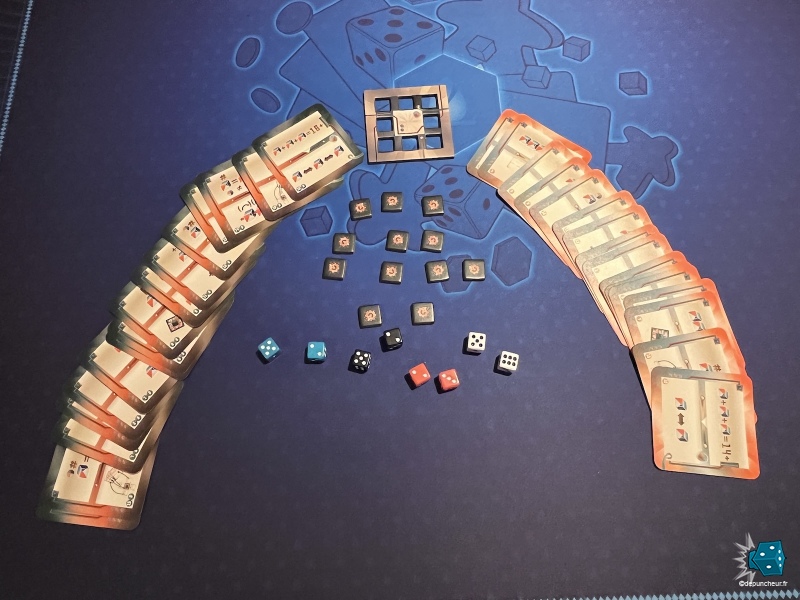 L'intégralité du matériel, un mini plateau, 32 cartes, 12 jetons et 8 dés